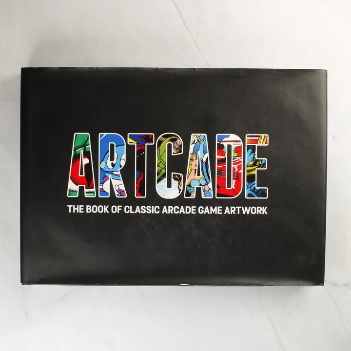 Az Artcade: The Book of Classic Arcade Game Artwork könyv fekete borítója színes felirattal.