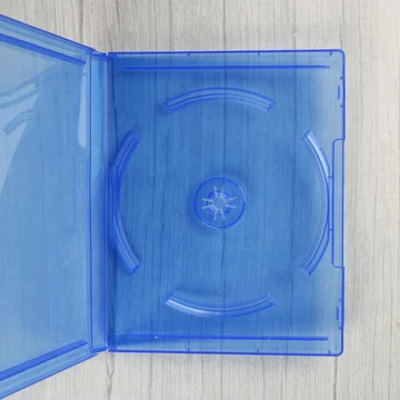 Nyitott, áttetsző kék videójáték tok belső lemeztartóval