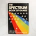 The Spectrum Book of Games könyv előlapja fekete alapon szivárvánnyal és pixelgrafikával