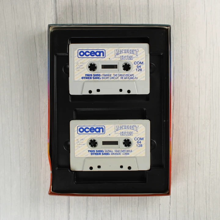 The Magnificent Seven kazetták Két szürke magnókazetta a fekete műanyag tartóban