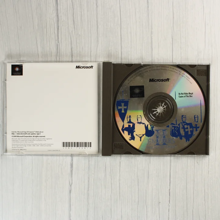 Nyitott CD-tok az Age of Empires II játéklemezzel.