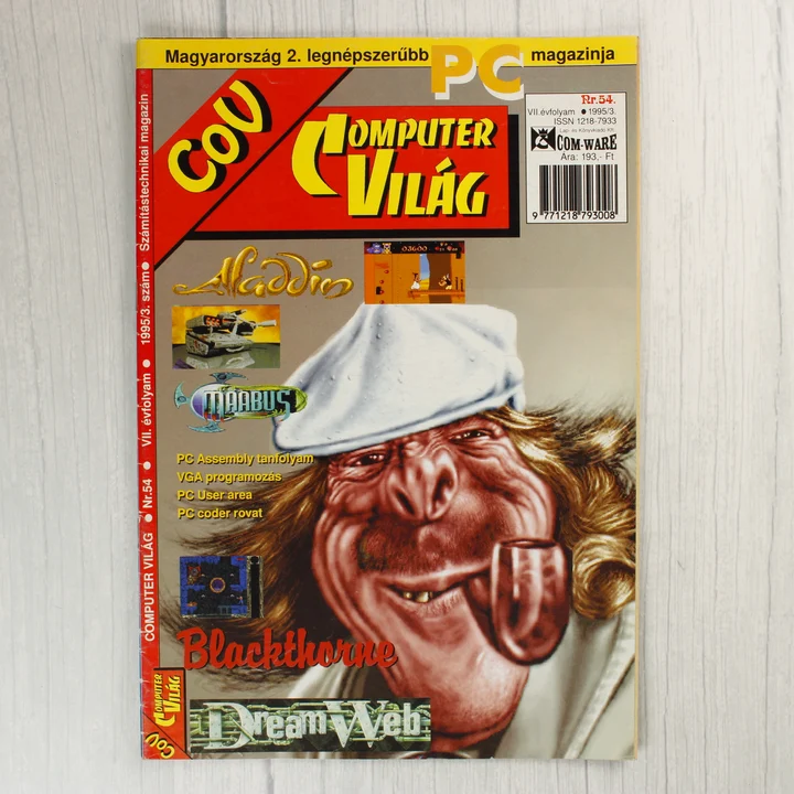 A Commodore Világ 54. számának címlapja egy pipázó karikatúrával.