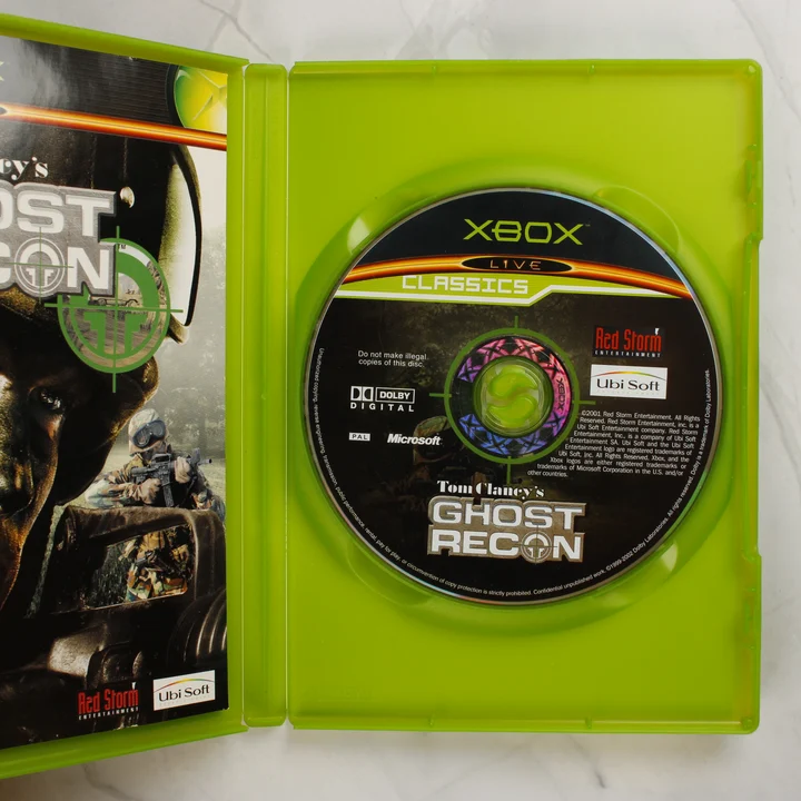 Nyitott Xbox tok a Ghost Recon játéklemezzel és kézikönyvvel