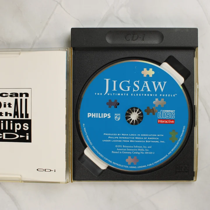 Nyitott Jigsaw Philips CD-i tok a lemezzel
