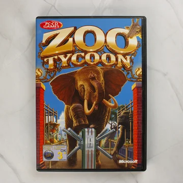 A Zoo Tycoon PC-s videójáték elülső borítója elefánttal és más állatokkal.