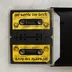 Két sárga címkés Commodore 64 kazetta a nyitott tokban