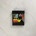 Fekete videójáték cartridge színes matricával
