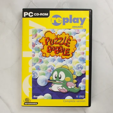 Puzzle Bobble PC játék sárga borítója fekete tokban