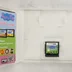 Nyitott Nintendo DS tok a Peppa Pig cartridge-dzsel és kiskönyvvel