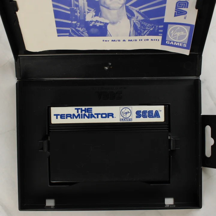Nyitott Sega Master System tok a The Terminator cartridge-dzsel és kézikönyvvel