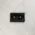 A fekete színű R-Type Commodore 64 kazetta közelről.