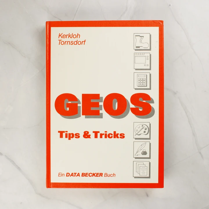 A GEOS Tips & Tricks könyv narancssárga és fehér borítója