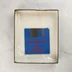 Kék floppy lemez az Archipelagos játék dobozában