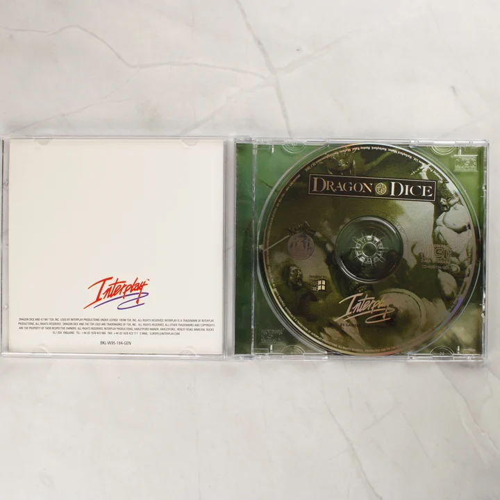 Dragon Dice CD lemez Nyitott Dragon Dice CD-tok a lemezzel és a hátlappal