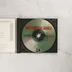 A nyitott CD-tok a lemezzel és a füzettel