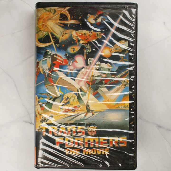 The Transformers: The Movie magyar kiadású VHS kazetta előlapja műanyag tokban