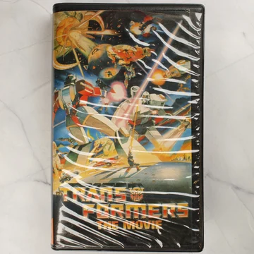 The Transformers: The Movie magyar kiadású VHS kazetta előlapja műanyag tokban