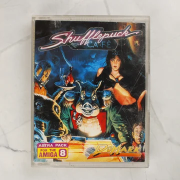 A Shufflepuck Café Amiga játék tokjának előlapja színes illusztrációval