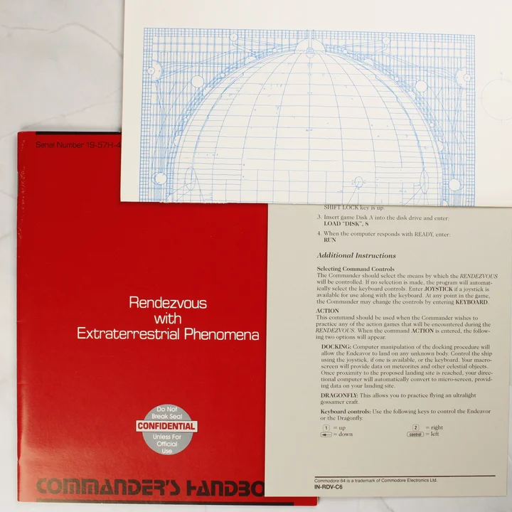 A játékhoz tartozó piros Commander's Handbook és egy kék technikai rajz