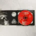 Nyitott CD-tok a piros színű Disc 2 lemezzel