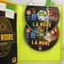Az L.A. Noire nyitott tokja a két játéklemezzel és a kiskönyvvel