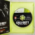 A nyitott Xbox 360 tok a Call of Duty Black Ops II lemezzel és a kiskönyvvel