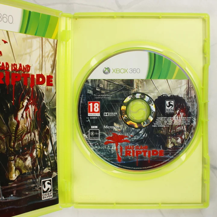 Nyitott Xbox 360 tok a Dead Island Riptide játéklemezzel