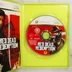 A nyitott Xbox 360 tok a Red Dead Redemption lemezzel és a kézikönyvvel