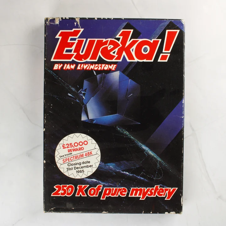 Az Eureka! videójáték dobozának előlapja Ian Livingstone nevével és a nyereményjáték matricájával.