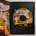 A nyitott tok a RollerCoaster Tycoon 3 CD-ROM lemezzel és a kézikönyvvel