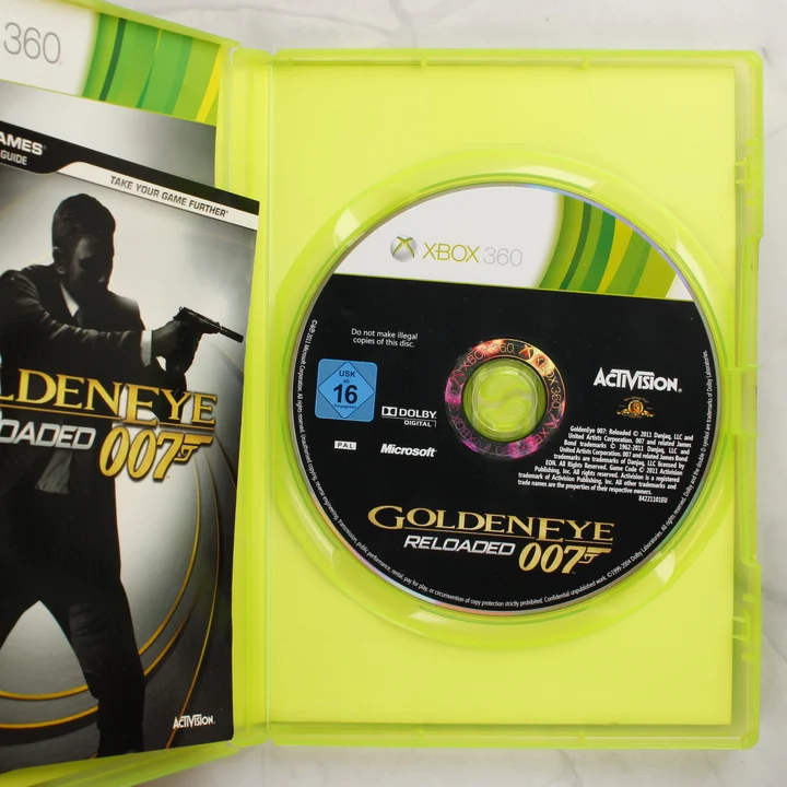 GoldenEye 007: Reloaded Xbox 360 lemez és kézikönyv Nyitott tok a GoldenEye 007: Reloaded játéklemezzel és kézikönyvvel