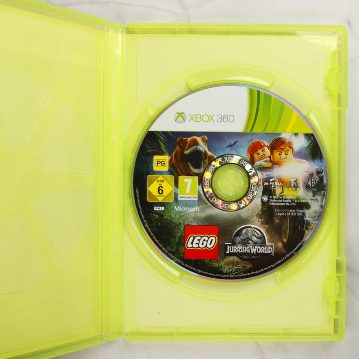 LEGO Jurassic World Xbox 360 lemez és belső tok A nyitott műanyag tok a LEGO Jurassic World játéklemezzel