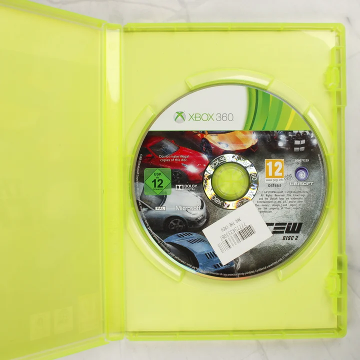 Nyitott Xbox 360 tok a The Crew Disc 2 játéklemezzel