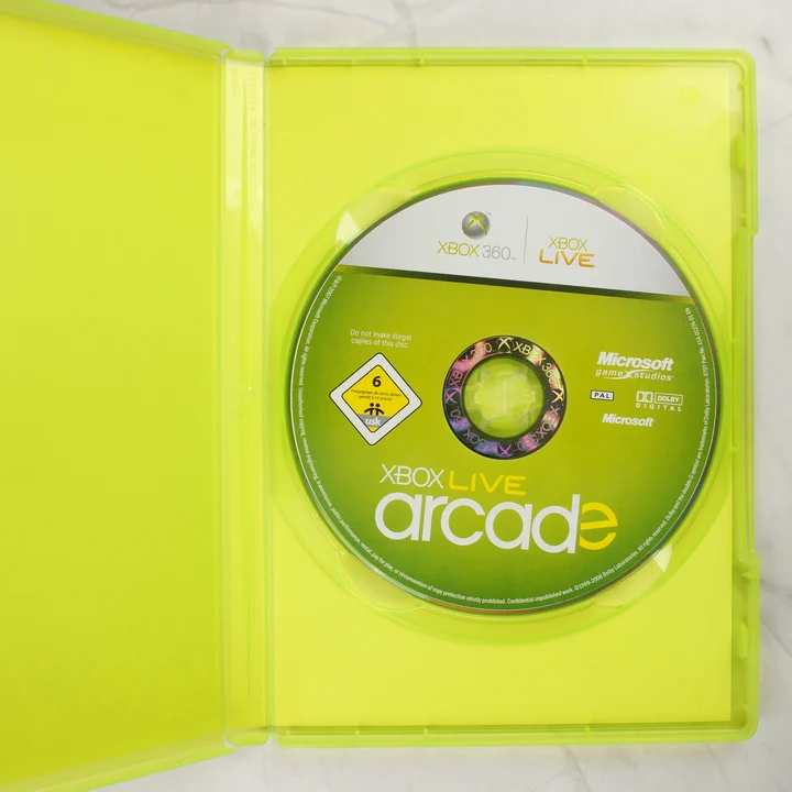 Xbox Live Arcade Compilation Disc kinyitott tok lemezzel Xbox Live Arcade Compilation Disc kinyitott tokban a lemez felőli oldal