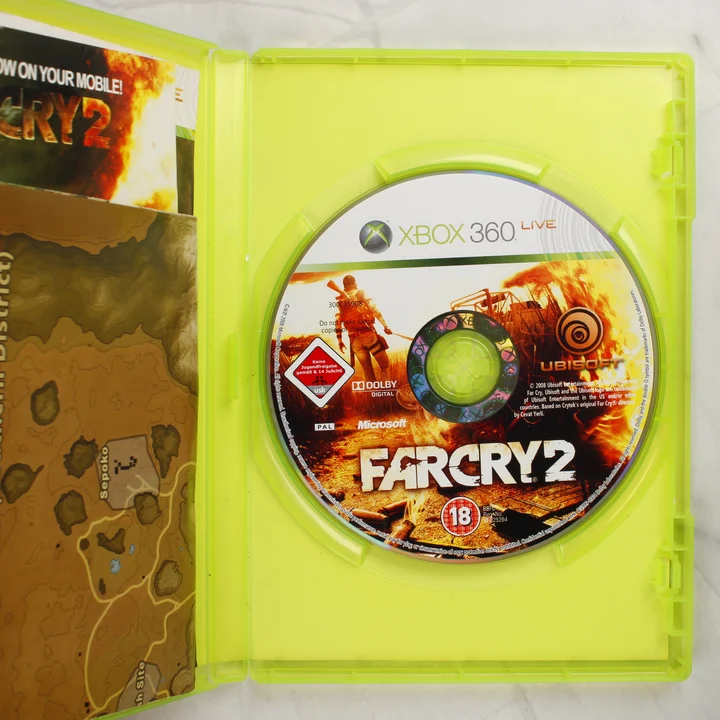 Nyitott Xbox 360 tok a Far Cry 2 lemezzel és a mellékelt térképpel