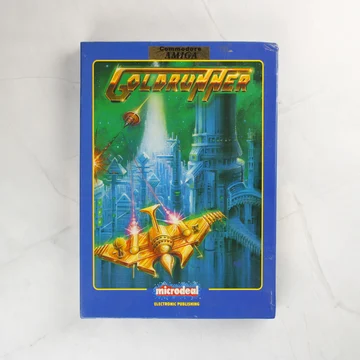 A Goldrunner videójáték kék dobozának előlapja egy arany űrhajóval.