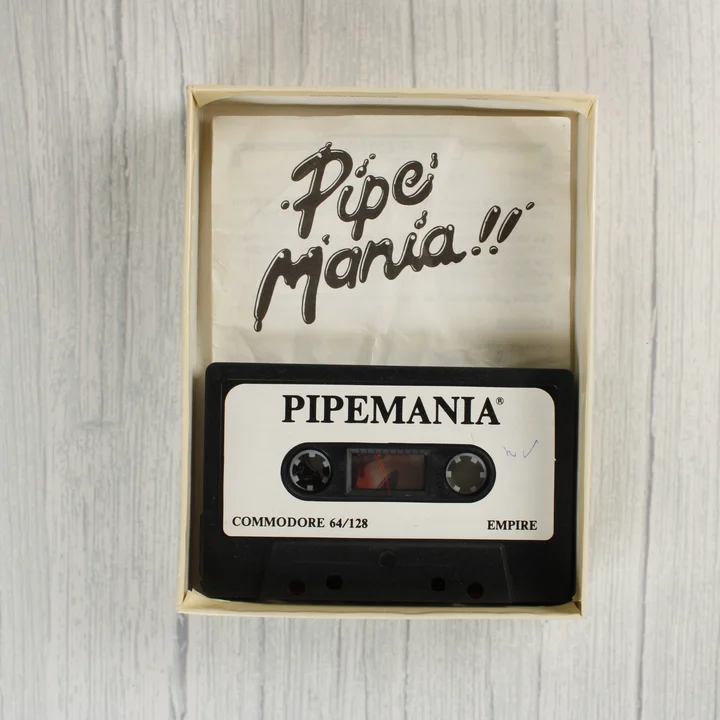 Pipe Mania Commodore 64 kazetta és útmutató a dobozban