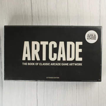 Artcade: The Book of Classic Arcade Game Artwork könyv előlapja fekete borítóval és fehér felirattal.