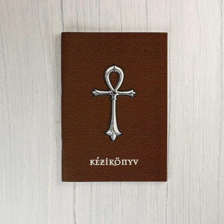 Barna színű magyar nyelvű kézikönyv ankh szimbólummal