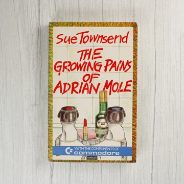 The Growing Pains of Adrian Mole könyv előlapja Commodore logóval