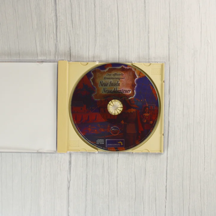 Nyitott CD-tok az Anno 1602 kiegészítő lemezével